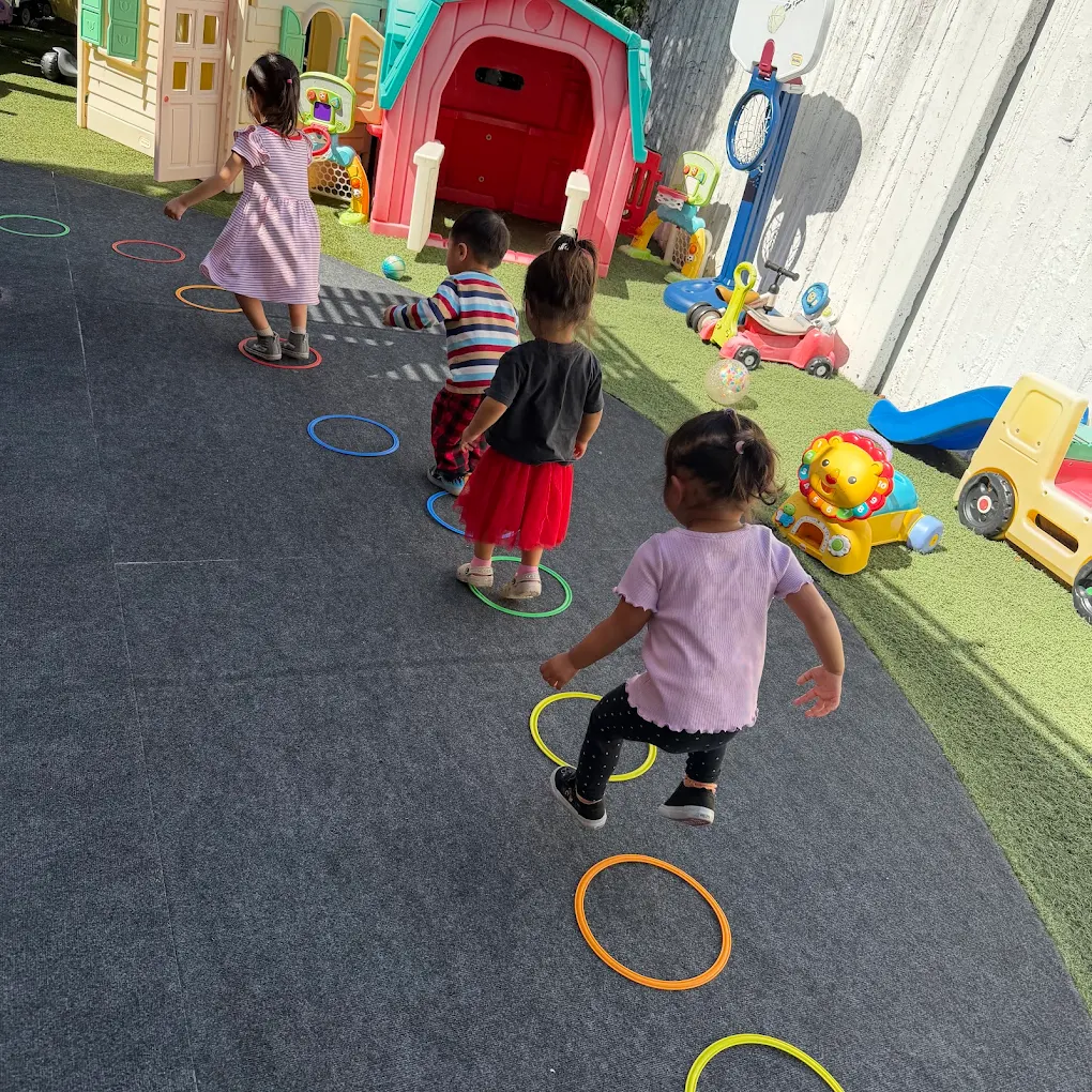 Toddlers gathered for circle time and outdoor play at Crayoland